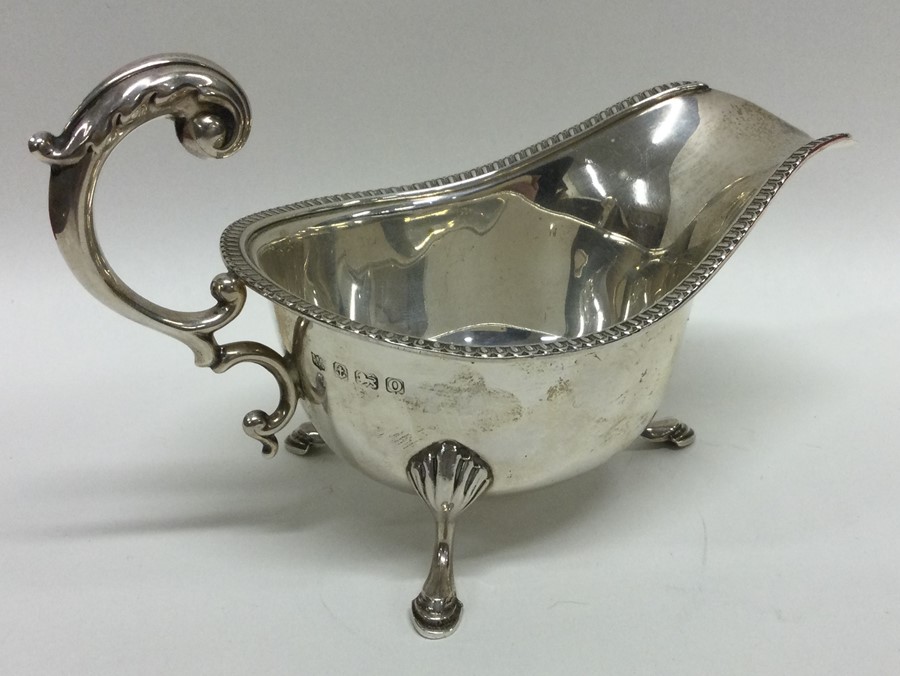 An Edwardian silver sauce boat with gadroon rim. B