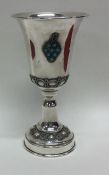 A silver Kiddush cup attractively decorated with t