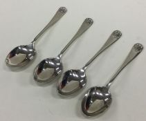 A set of four OE and shell pattern silver coffee s