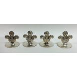 A heavy set of four silver menu holders in the for