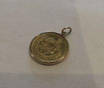 A heavy 9 carat pendant in the form of a coin. App