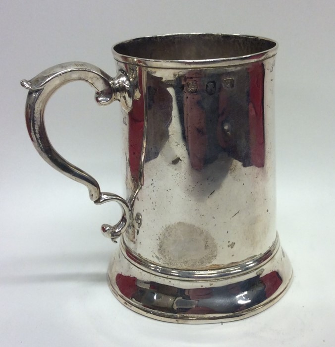 An early Georgian silver tapering mug on spreading