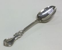 A Victorian silver spoon decorated with scrolls. L