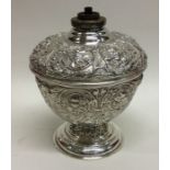 A rare Victorian silver embossed oil lamp attracti