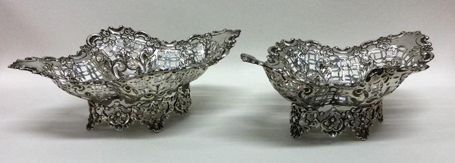A pair of stylish silver bonbon dishes decorated w