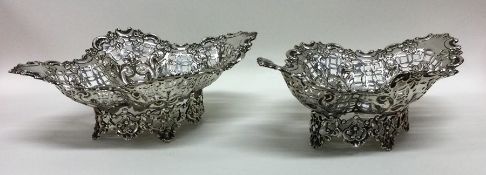 A pair of stylish silver bonbon dishes decorated w