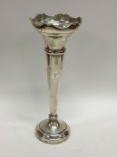 A tapering silver spill vase with shaped rim. Birm