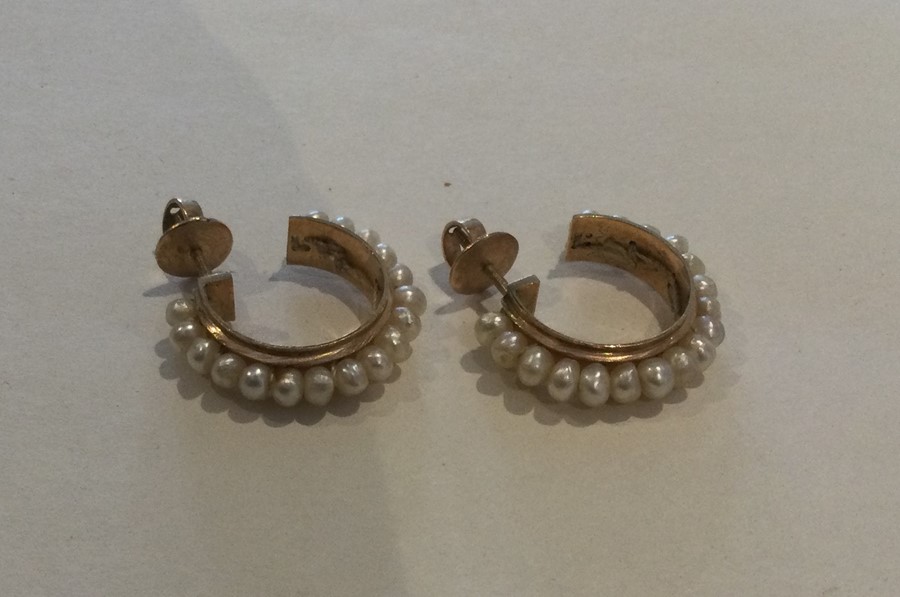 A pair of Continental pearl and gold hoop earrings