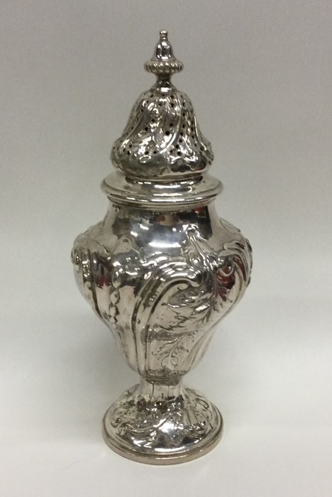 A good Georgian chased silver sugar caster with li