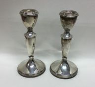 A pair of Edwardian circular silver tapering candl