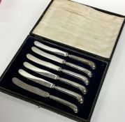 A set of six silver pistol handled knives containe