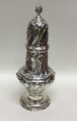 A massive Victorian silver sugar caster of swirl f