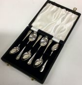 A cased set of six OE and shell pattern silver tea