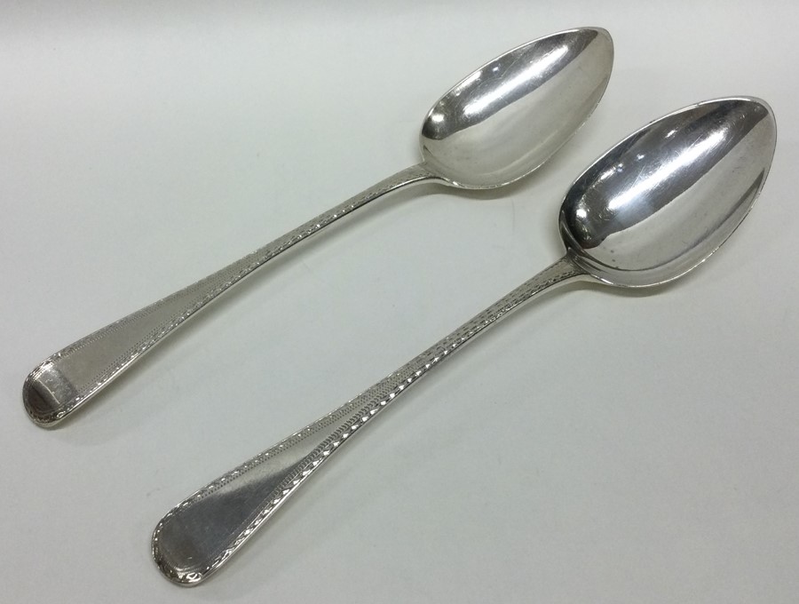 A pair of attractive feather edged silver tablespo