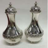 A good pair of Victorian silver peppers with flora