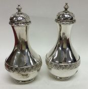 A good pair of Victorian silver peppers with flora