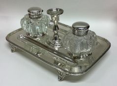 A Victorian silver inkwell with beaded rim to hing