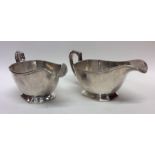 A pair of heavy silver sauce boats with cut corner