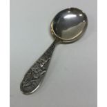 An unusual silver caddy spoon decorated with a nur