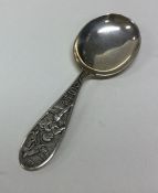 An unusual silver caddy spoon decorated with a nur