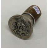 A chased silver stopper decorated with drunken fig