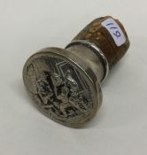 A chased silver stopper decorated with drunken fig