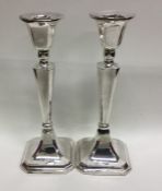 A pair of tapering silver candlesticks. London. Ap