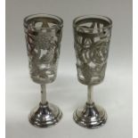 A pair of silver and overlaid shot glasses. Approx