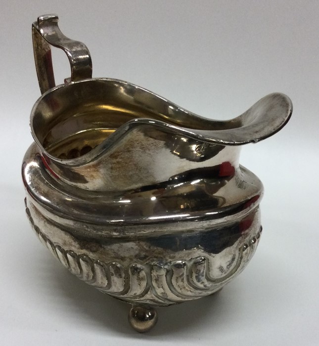 A Georgian silver half fluted cream jug on ball fe - Image 2 of 2