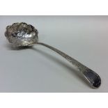 A Georgian silver sifter spoon decorated with vine