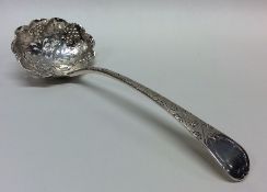 A Georgian silver sifter spoon decorated with vine