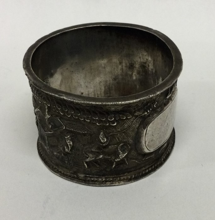 A Chinese silver napkin ring decorated with figure