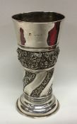 A tall stylish silver spill vase embossed with flo