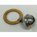 A circular silver rattle together with wooden teet