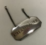 An unusual silver plated wine label for 'Champagne