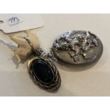 A Continental silver locket together with a brooch