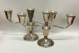 A heavy pair of American silver candelabra. By Emp