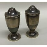 A pair of tapering silver engine turned cruets. Bi