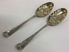 A heavy pair of Georgian silver berry spoons attra
