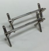 A heavy pair of Edwardian silver knife rests in th