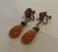 A pair of silver and hard stone earrings with fili