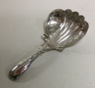 A heavy silver engraved caddy spoon with fluted bo