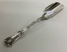 An American silver cheese scoop decorated with scr
