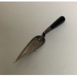 A small silver bookmark in the form of a trowel. A