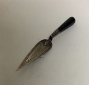 A small silver bookmark in the form of a trowel. A