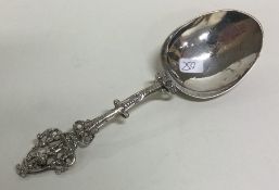 A Continental silver spoon with cast handle. Appro