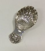 A small Edwardian silver caddy spoon with fluted b