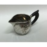 An Antique French silver cream jug with embossed d