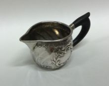 An Antique French silver cream jug with embossed d