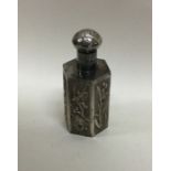 A Chinese silver scent bottle decorated in relief.